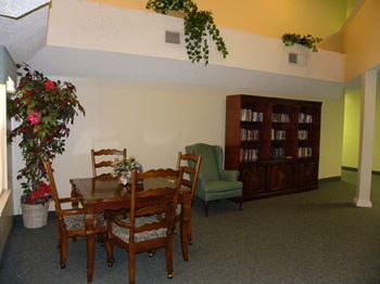 A dining room with a table and chairs.